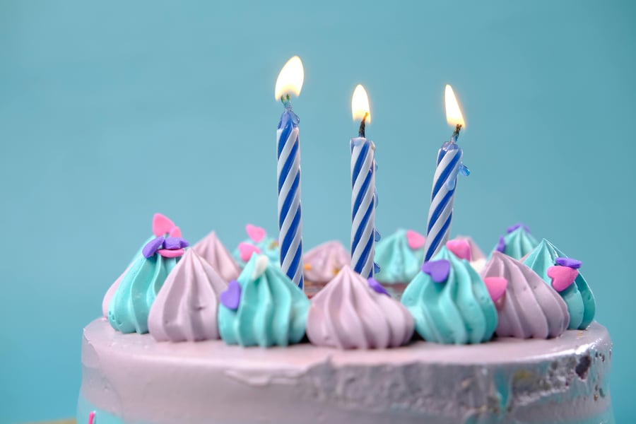 Birthday cake with lit candles.