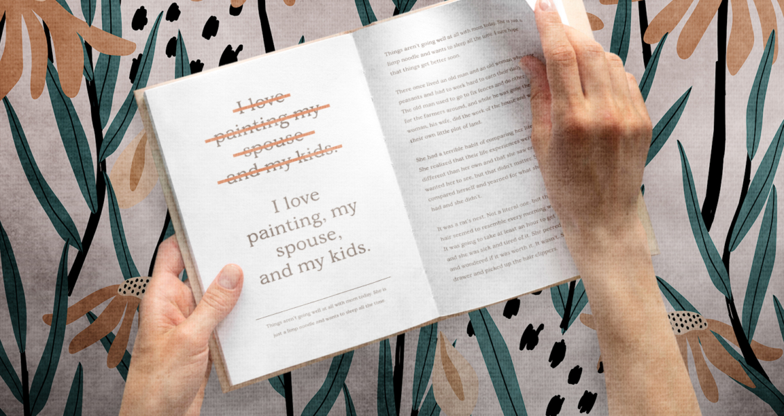 Hands holding an open book with text. Some words are crossed out, leaving "I love painting, my spouse, and my kids." Background has a floral pattern.