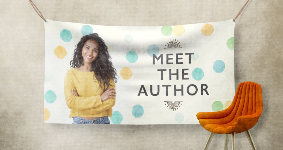 A banner with a smiling person in a yellow sweater on the left and the text "MEET THE AUTHOR" on the right, hanging against a wall with an orange chair in the foreground.