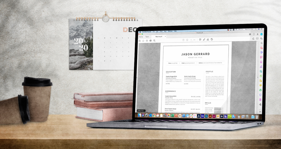 A laptop displaying a resume is on a wooden desk with a coffee cup, books, and a calendar showing December 2020 in the background.