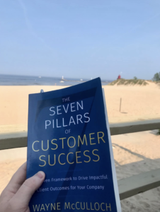 Wayne McCulloch at the beach with book