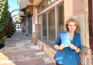 patty holding book outside