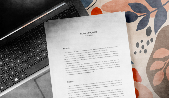 feature image printed book proposal on top of laptop