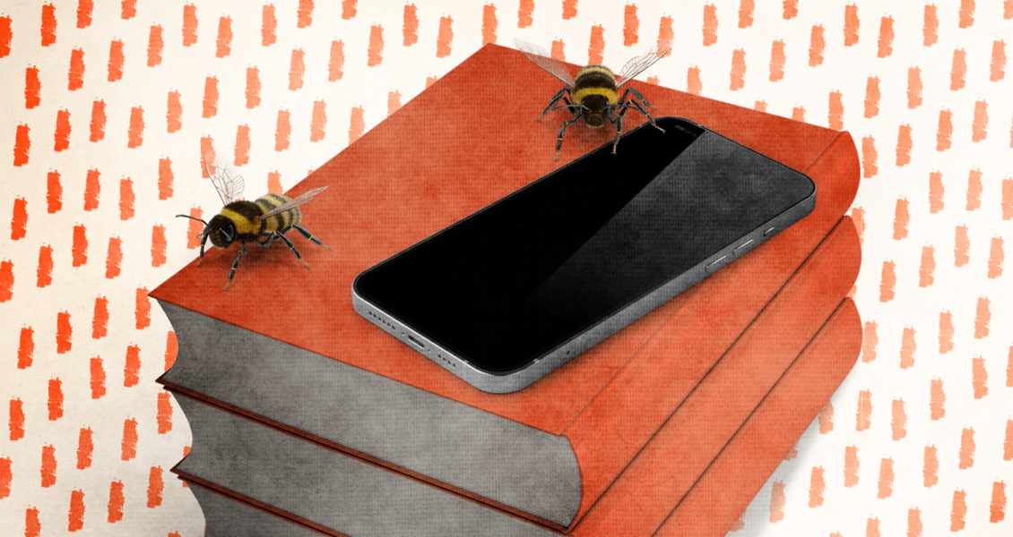 phone on stack of books with bees