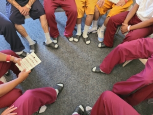 inmates sitting in book circle