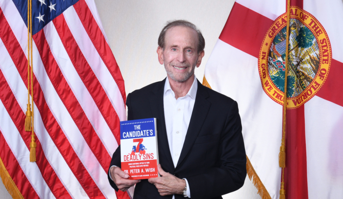 feature image Dr. Wish with book in front of flags
